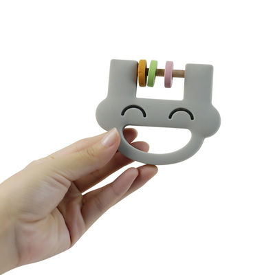 El traqueteo lindo Teether del silicón de los juguetes de los niños del silicón de la cara de la sonrisa con modifica el ODM del OEM para requisitos particulares del logotipo